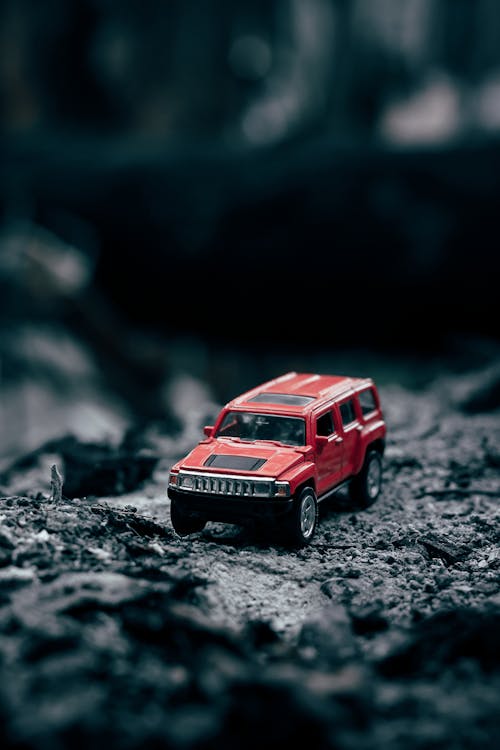 Selective Focus Photo of a Red Miniature Car