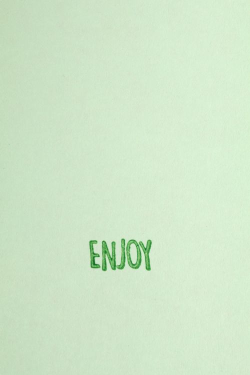 Free Simple green background with 'Enjoy' text for motivational use. Stock Photo