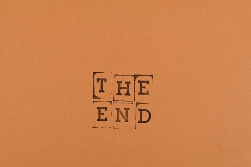 Free Stamped text 'The End' on an orange background offering creative copyspace. Stock Photo