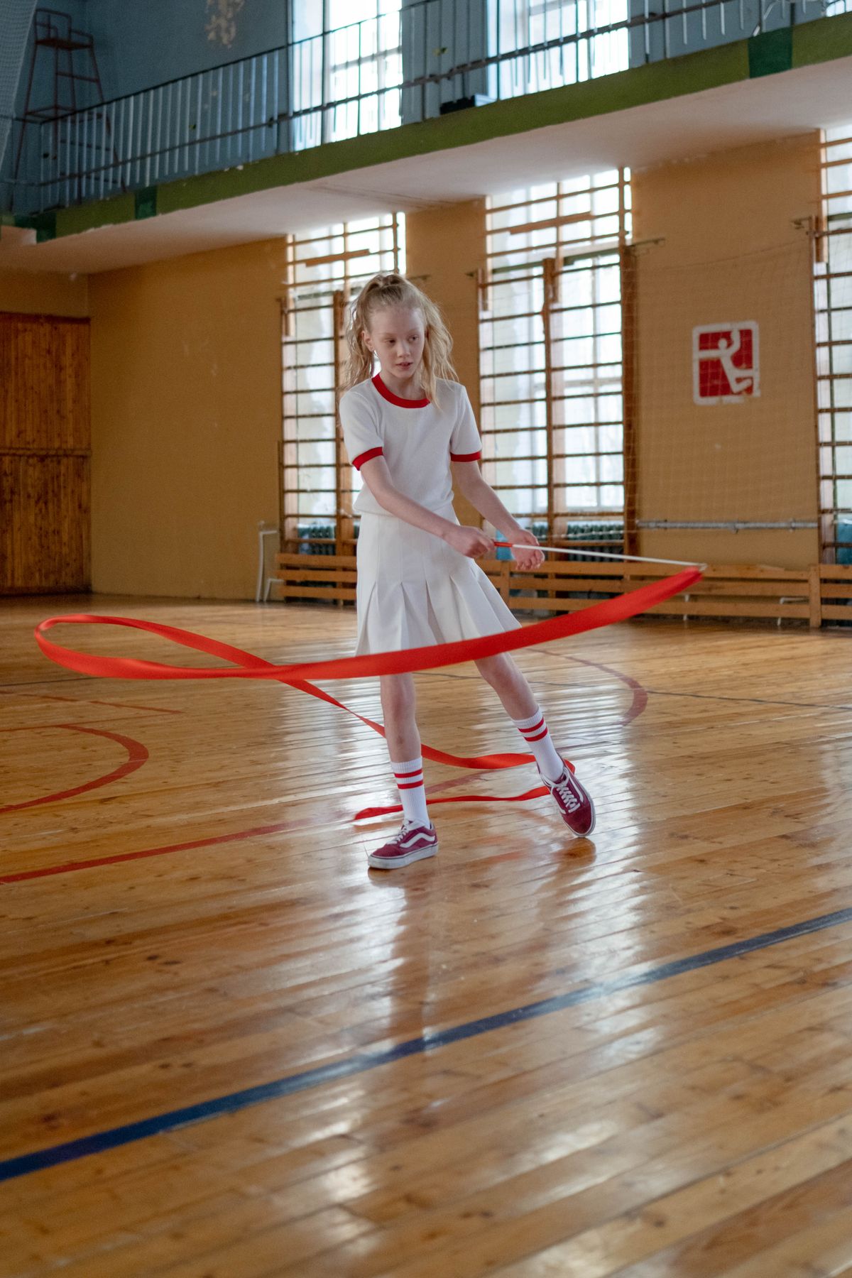 Child practicing rhythmic gymnastics