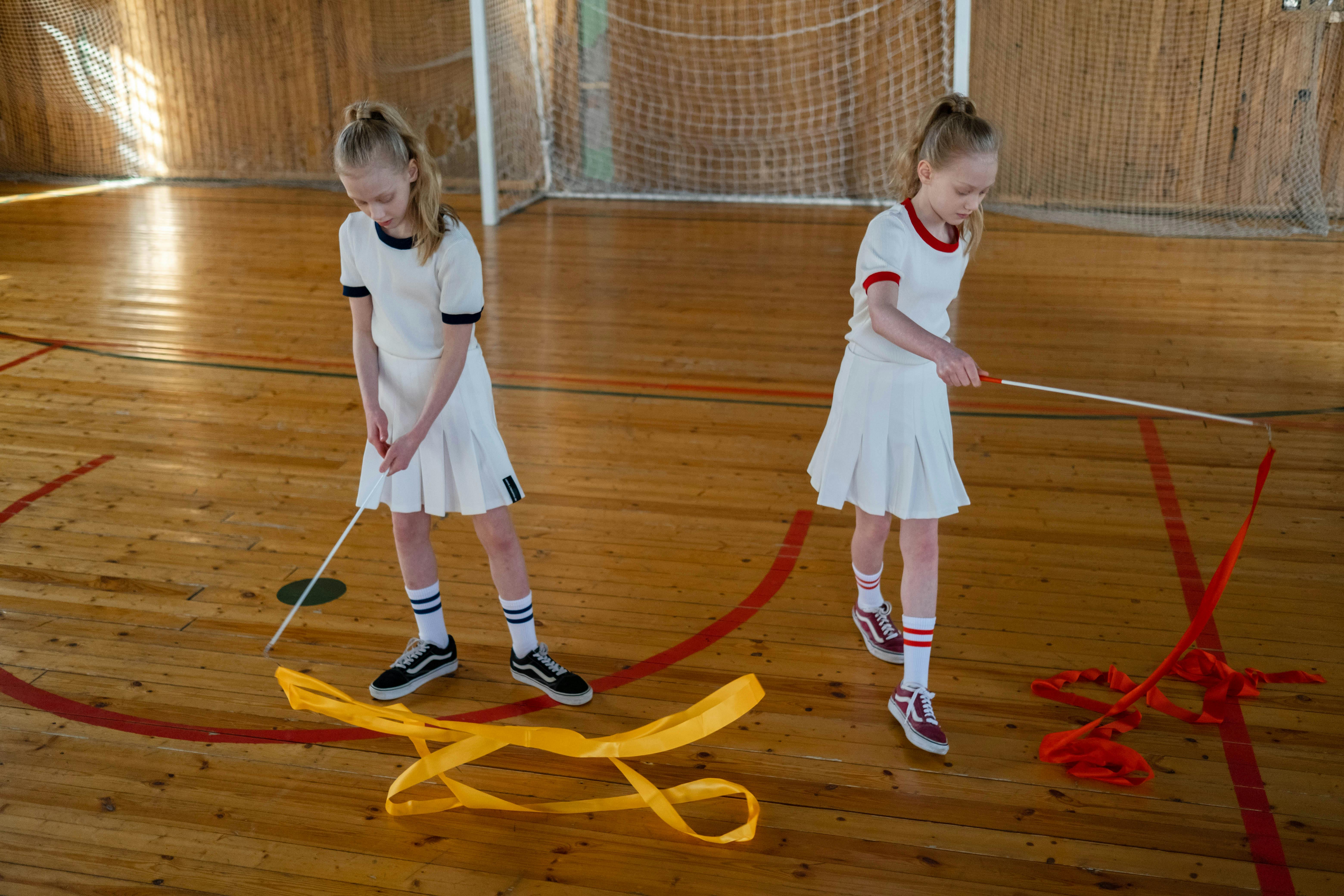 twins doing rhythmic gymnastics