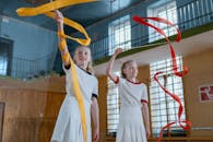 Two Girls Having Fun Practicing Rhythmic Gymnastics