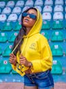 A Woman in Yellow Hoodie Wearing Black Sunglasses