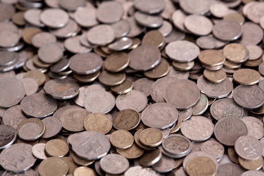 A detailed view of assorted coins forming a large pile, ideal for financial themes.