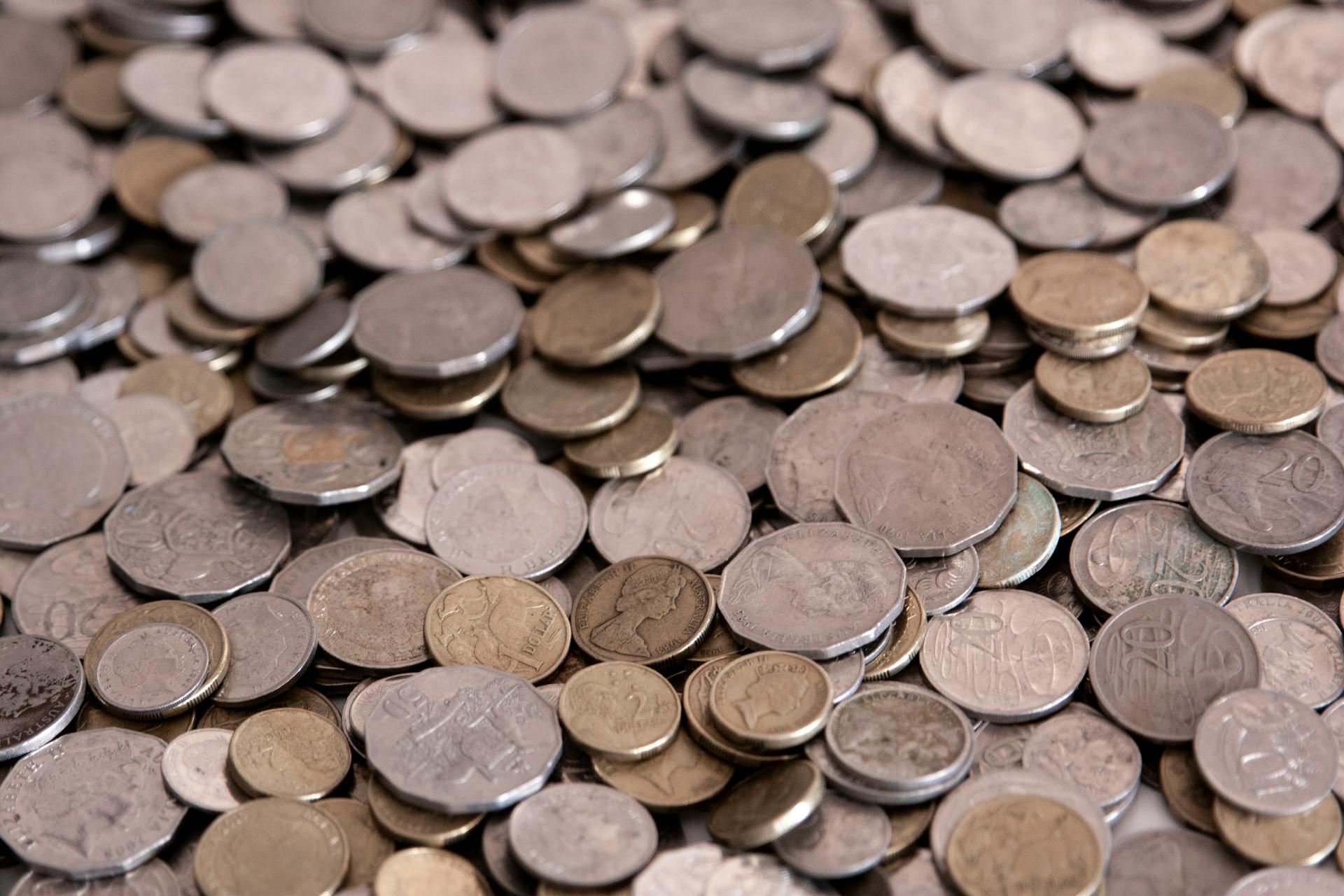 A detailed view of assorted coins forming a large pile, ideal for financial themes.