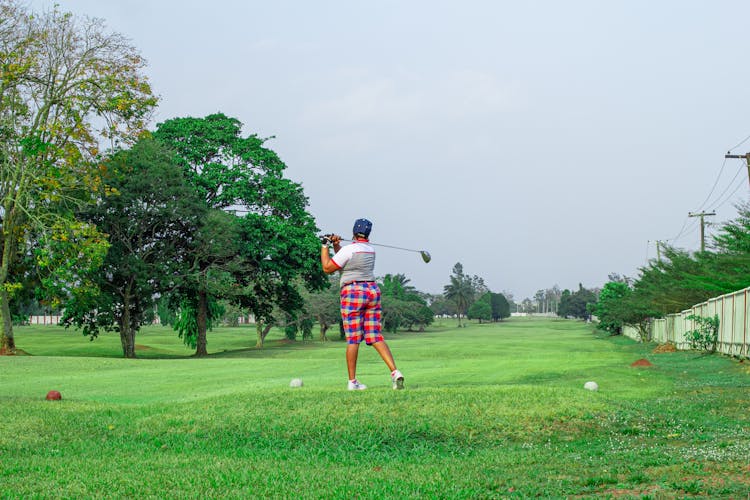 Back View Of A Person Playing Golf