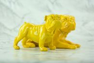 Close-Up Photo of Two Yellow Bulldog Figurines