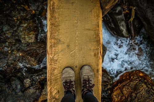 Person Standing on Wooden Plank