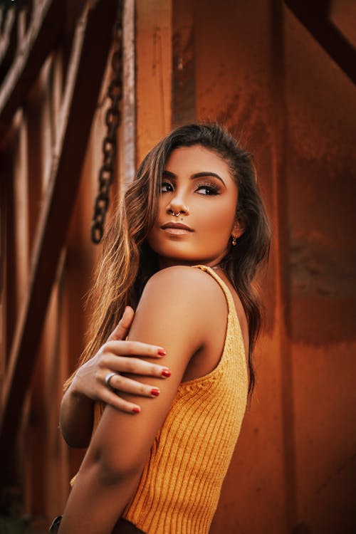 Woman in Yellow Top and Pierced Nose Looking Back