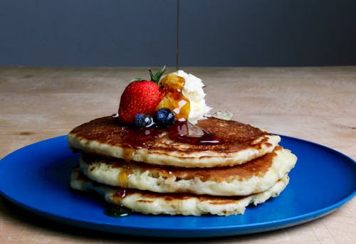 Free Pancakes With Strawberry, Blueberries, and Maple Syrup Stock Photo