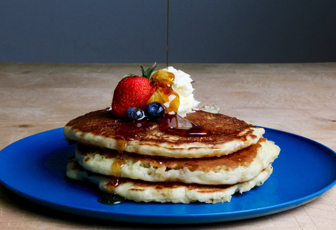 Pancakes With Strawberry, Blueberries, and Maple Syrup