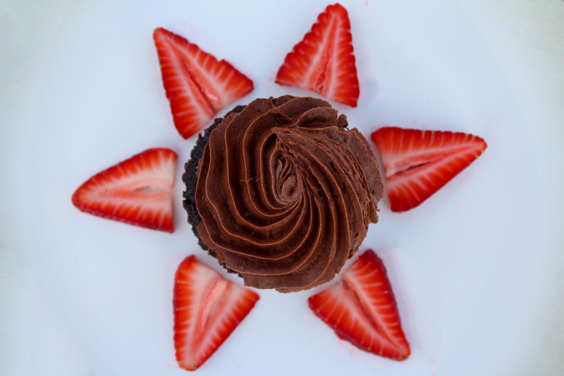 Chocolate strawberry cupcake on white plate