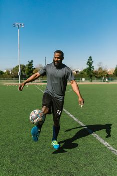 A man enjoying a casual soccer practice on a sunny day at a field.