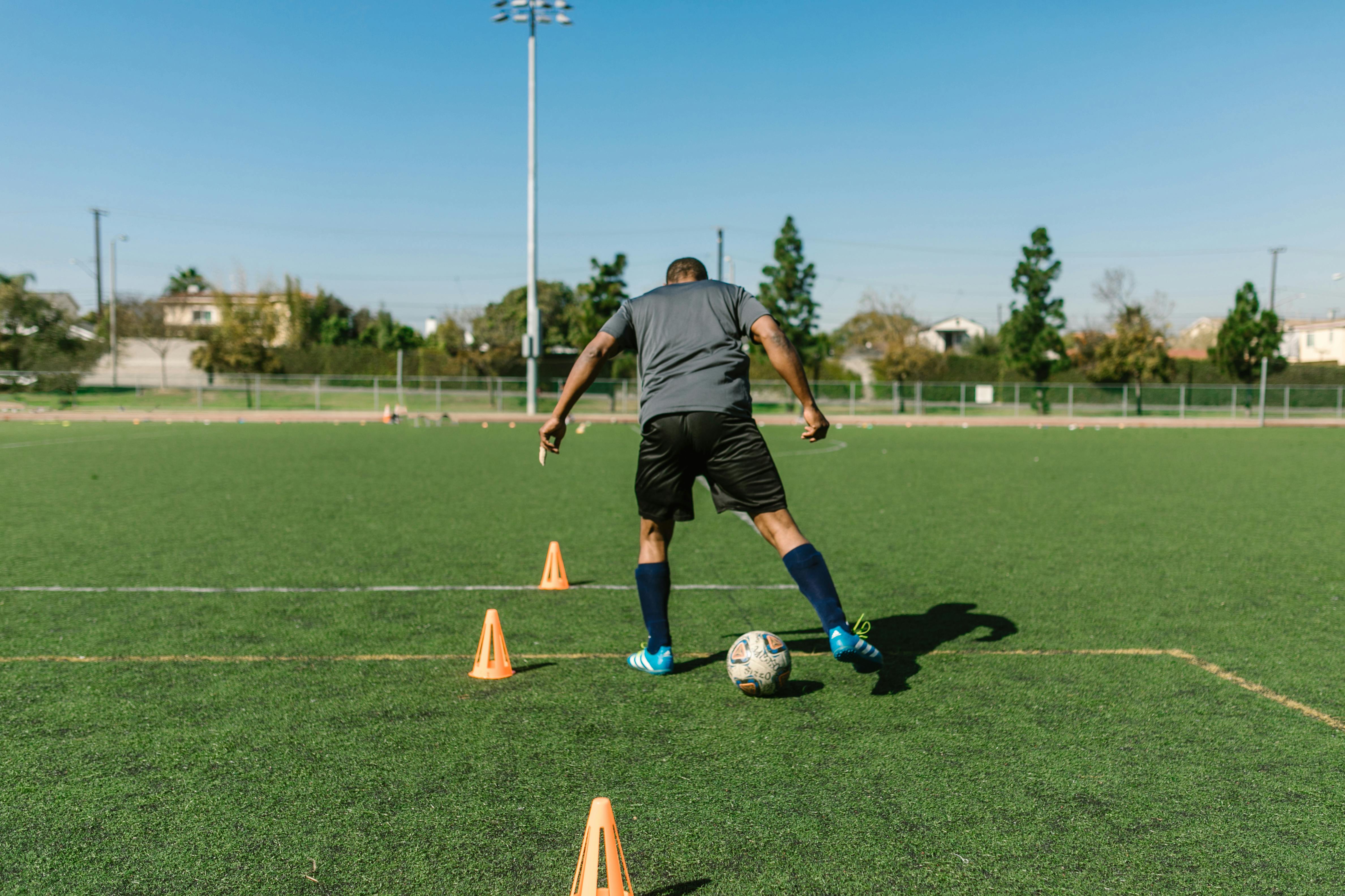 a man kicking a soccer ball