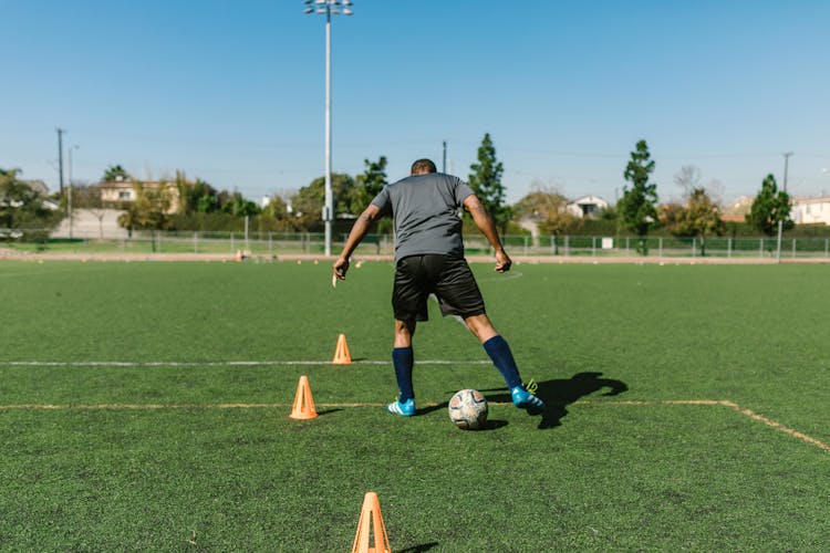 A Man Kicking A Soccer Ball