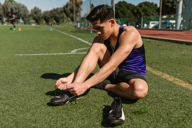 A Man Tying His Shoelace