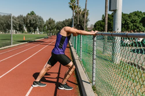 Free Side View of a Man Warming Up His Body Stock Photo