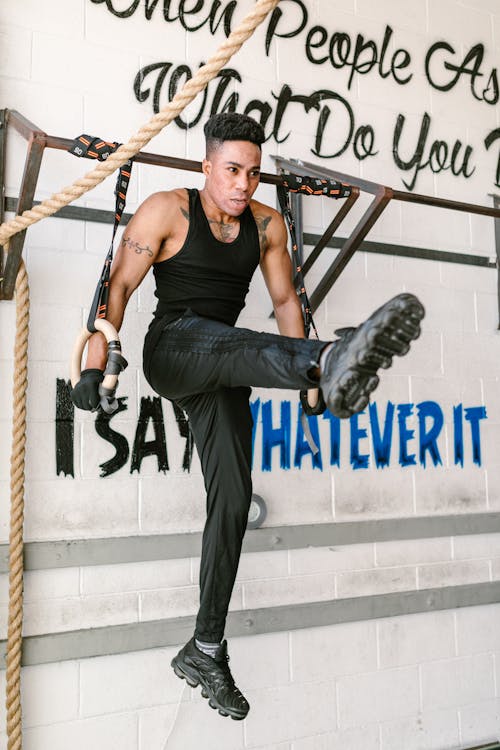 A Brawny Man in Activewear Exercising in the Gym