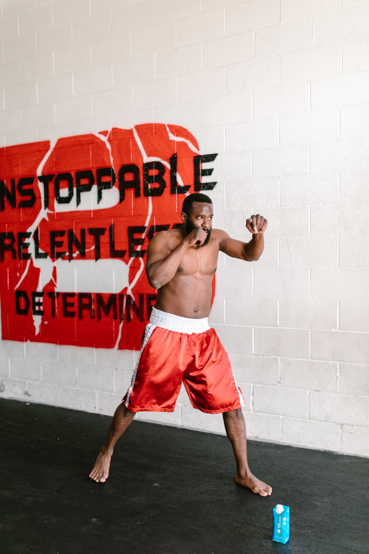 A Shirtless Man Shadowboxing