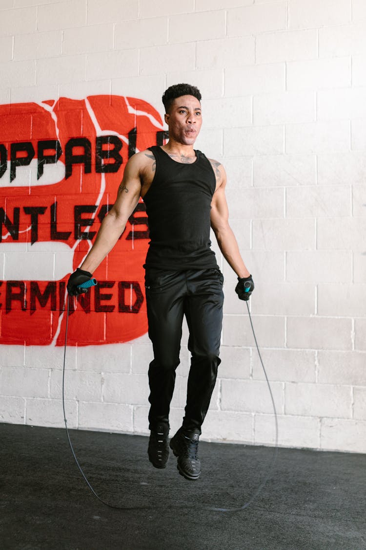 Man In Black Shirt Training With Jumping Rope