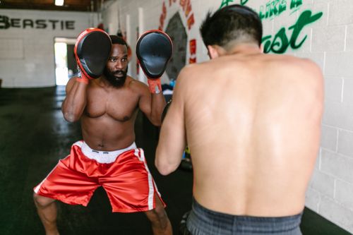 Free Boxers practicing in a gym, focusing on skills and fitness. Stock Photo
