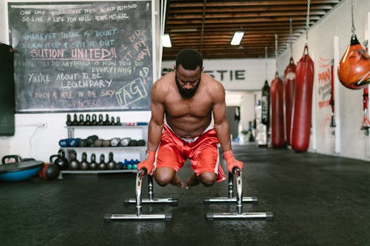Muscular man engaged in a calisthenics workout indoors, showcasing strength and fitness.