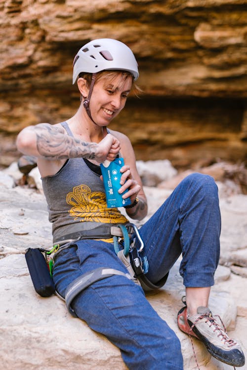 A Rock Climber Opening her Beverage