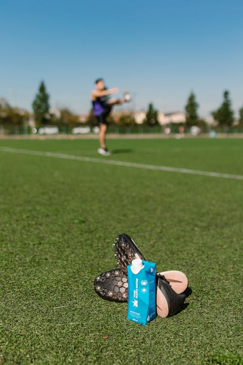 Close-up Photo of Cleats with Energy Drink 