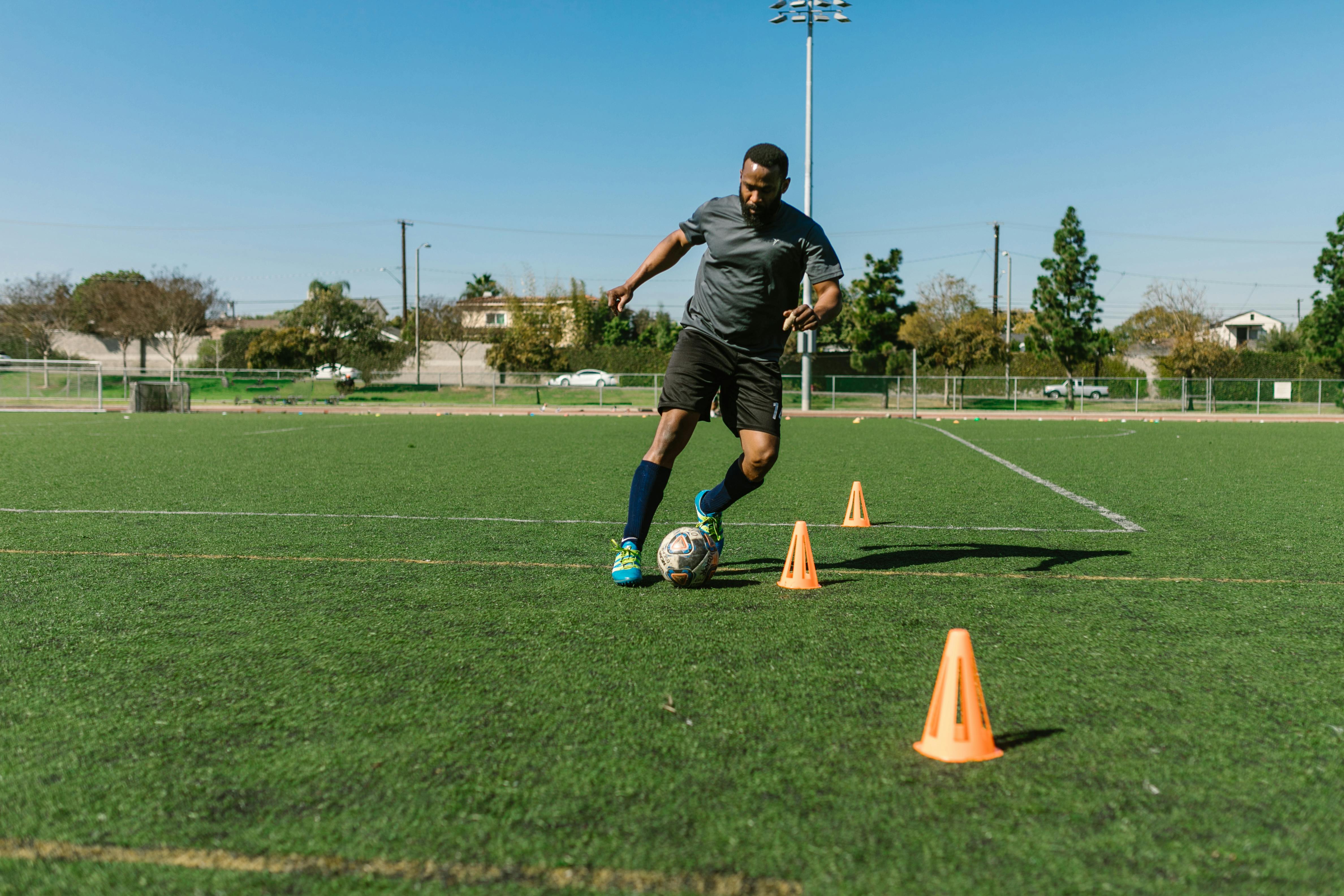 A Man Doing Football Tricks on the Field · Free Stock Photo