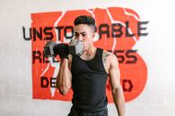 Man in Black Tank Top Holding Black Dumbbell