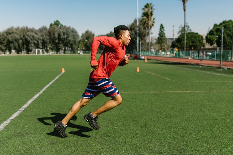 Boy Running On Football Field