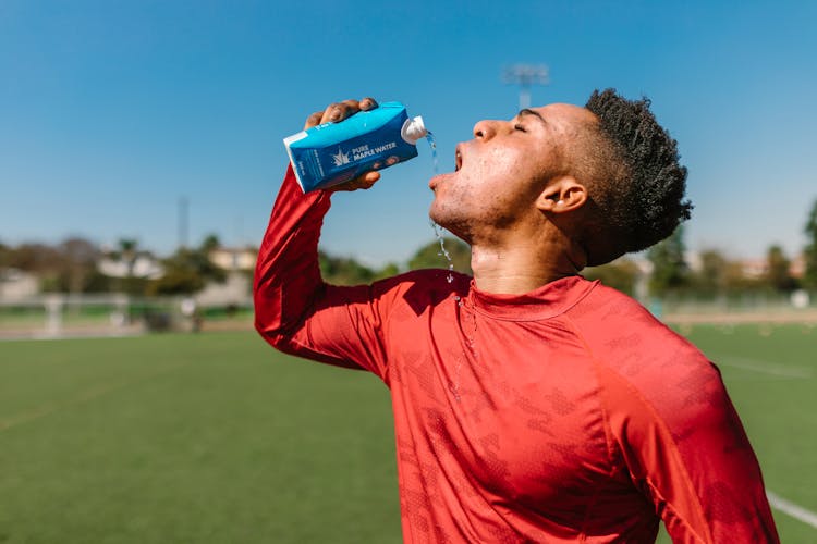 Close Up Photo Of An Athlete Drinking Beverage 