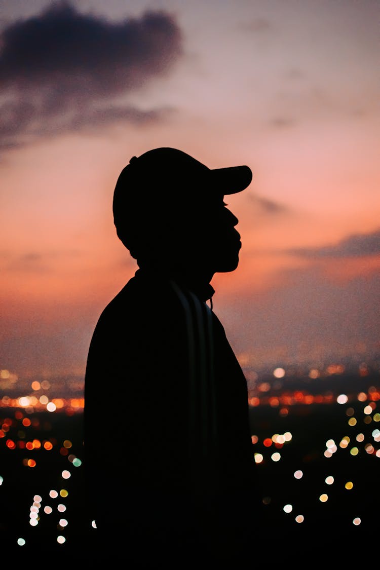 Silhouette Of Man Wearing Hat During Sunset