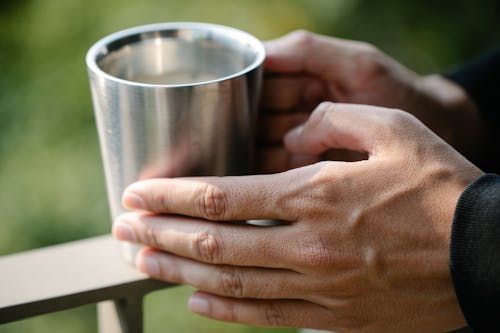 Photo of Person Holding Stainless Cup 