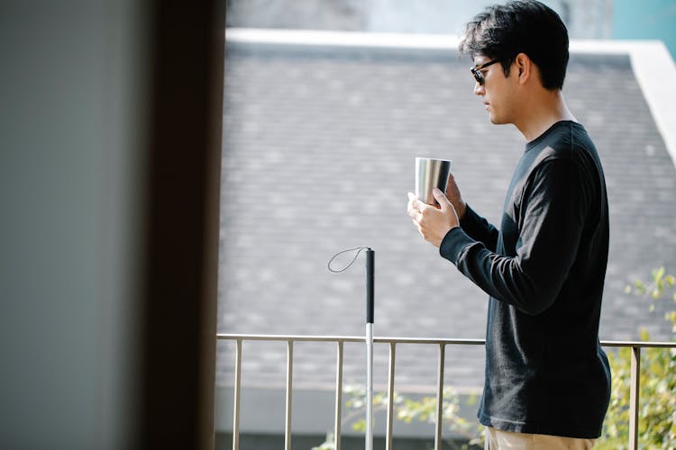 Photo Of Man Drinking Coffee In The Balcony