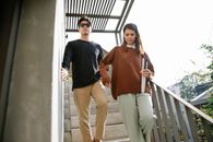 Photo of Woman Helping Man to Walk Down the Stairs