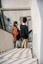 Photo of Man and Woman Walking Down the Stairs