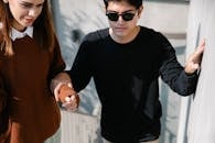 Photo of Man Holding Woman's Arm