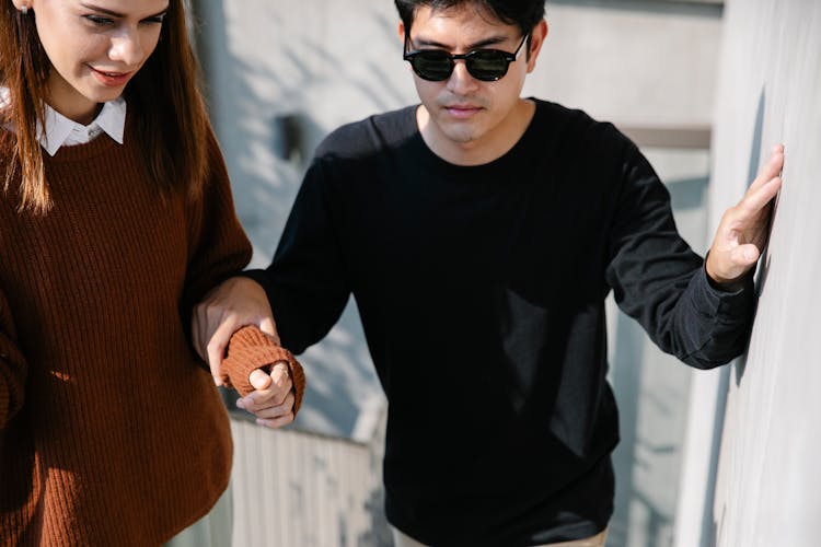 Photo Of Man Holding Woman's Arm 