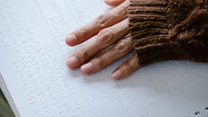 Close-Up Photo of Person Using Braille