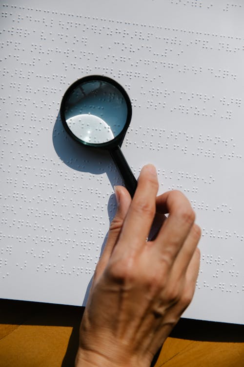 Photo of Person Holding Magnifying Glass 