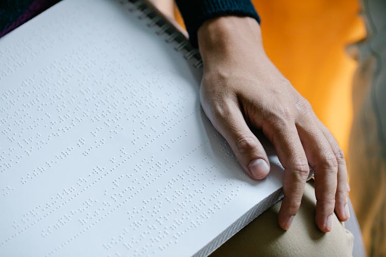 Photo Of Braille On Person's Lap