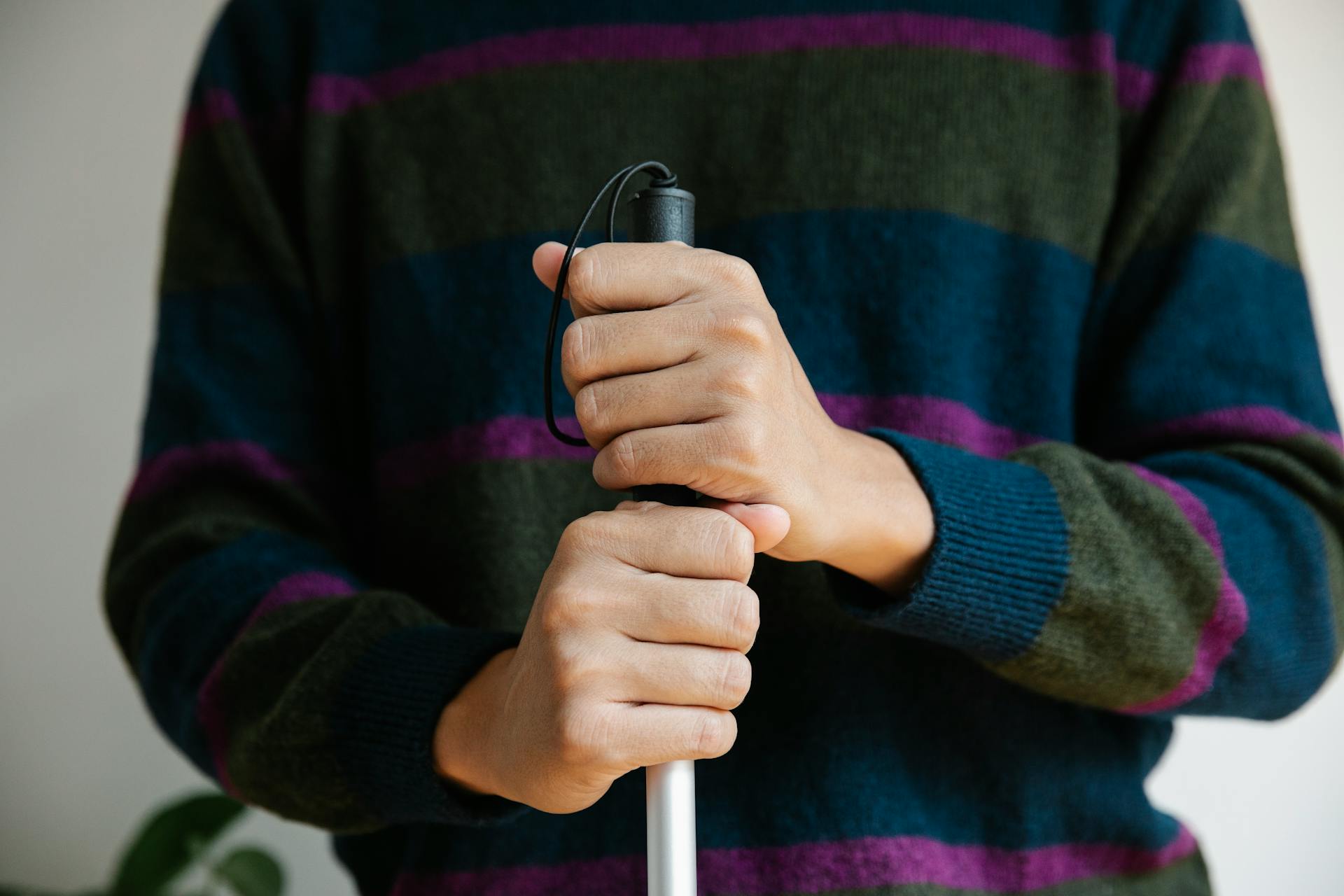 Photo of Person Holding Walking Stick