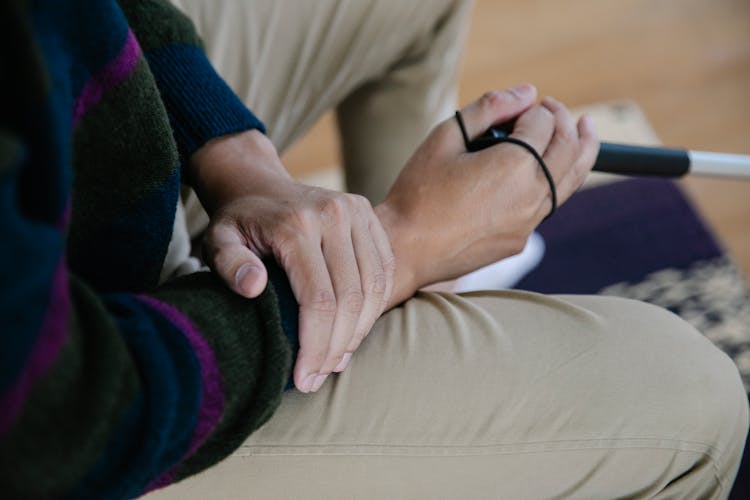 Close-up Photo Of Person Holding His Arm 