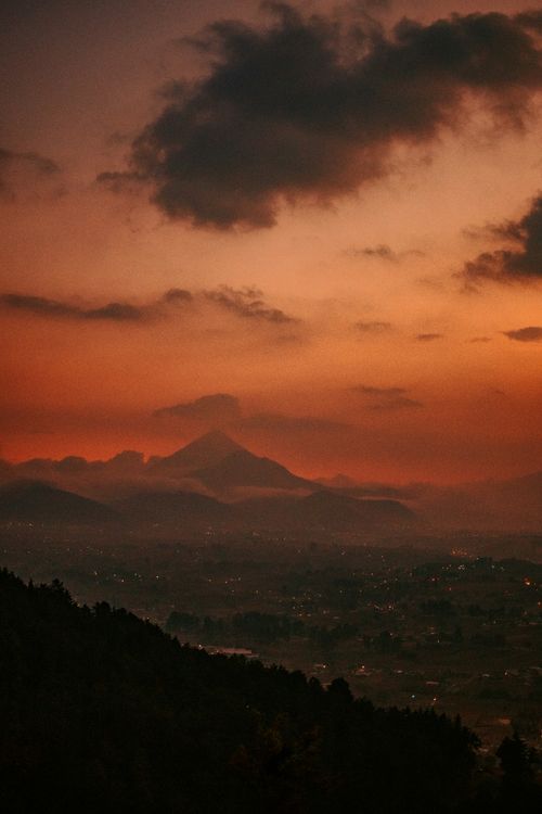 Free Stunning view of a mountain landscape at sunset with vibrant skies and outlined peaks. Stock Photo
