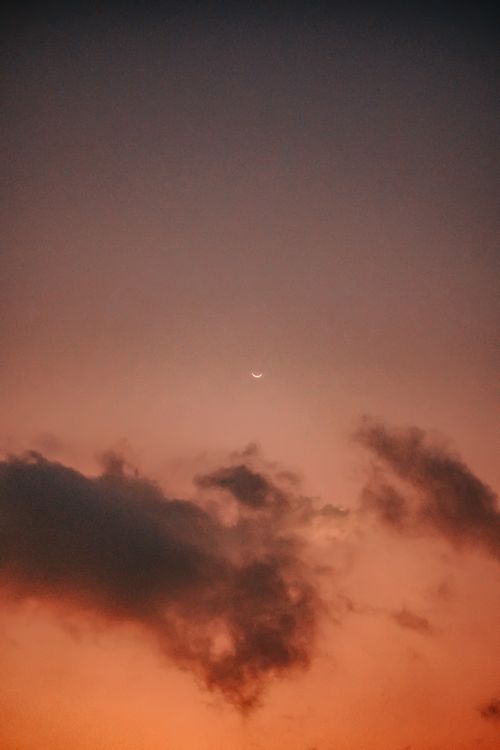 Free Peaceful twilight sky showcasing crescent moon and dramatic clouds. Stock Photo