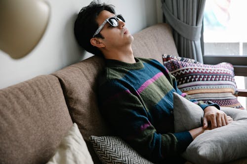 Photo of Man Resting on Couch