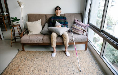 Photo of Man Leaning His Head on Wall 