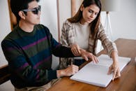 Photo of Woman Assisting Man