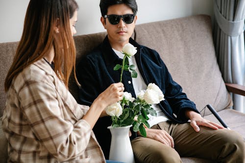 Photo of Woman Holding White Rose